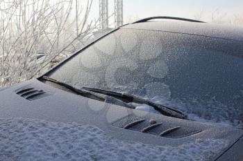 Frozen and snow-covered black car glass 30397