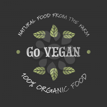 Engraved Go Vegan icon with leafs on black background