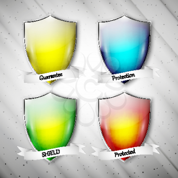 Empty isolated colored shields on dirty gray background. Vector format.
