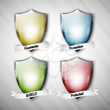 Empty isolated colored shields on dirty gray background. Vector format.