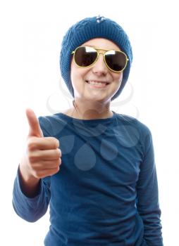 Girl wearing a knitted hat and sunglasses showing thumbs up