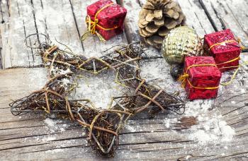 Decorative Christmas star from a wire and decoration on wooden background