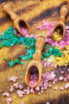 Sea salt for Spa relaxation treatments on the background of wooden scoops