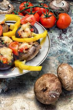 Easy appetizer of mushrooms stuffed with cheese,garlic and tomatoes.Photo tinted.