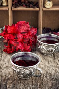 Hibiscus tea rose and welding on the background of the tea shelves in vintage style.Photo tinted