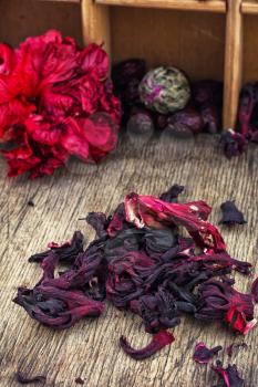 Hibiscus tea rose and welding on the background of the tea shelves in vintage style.Photo tinted