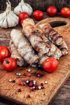 cooked meat products with spices and tomatoes.Selective focus.Photo tinted