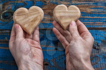 two symbolic wooden heart in your hands