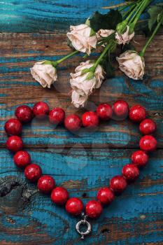 coral beads laid out in the shape of heart