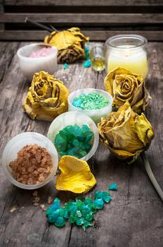 sea aromatic salt for Spa treatments on the background of yellow rose buds