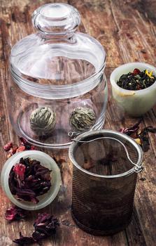 different varieties of brewed leaf tea in glass jar. The image is tinted in vintage style