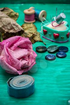 dried rose and buttons and sewing tools in refocuse.Selective focus