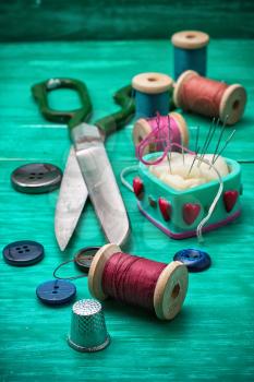 thread buttons for crafts on turquoise wooden background.Selective focus