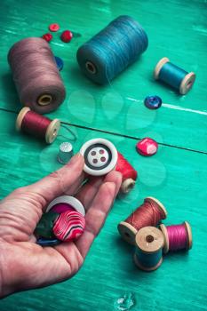 hand dressmaker with wooden buttons .Selective focus