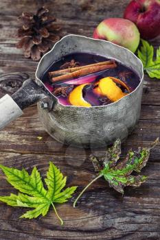 retro pot with mulled wine in the autumn still life