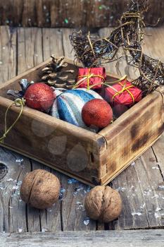 Stylish wooden box with Christmas decorations and pine cones