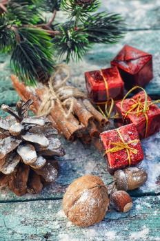 Christmas decorations,cone,cinnamon and nuts on wooden background