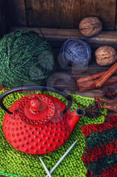 Balls of wool for knitting and stylish red kettle