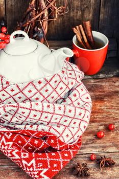 White custard glass teapot with warm scarf in country style