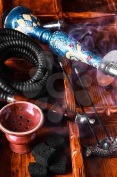 Dismantled parts of hookah on wooden background 