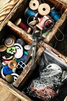 Retro composition with buttons and thread in a wooden box