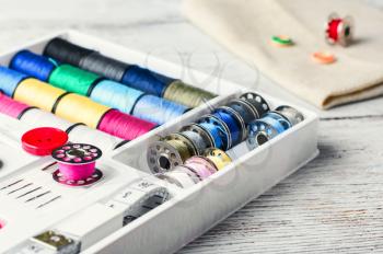 Beads,thread and bobbins for needlework.Picture in light key