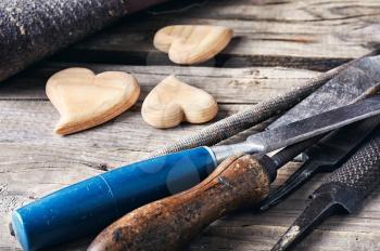 Symbolic wooden hearts cut by hand and carpenter tools