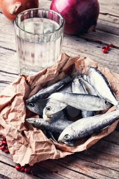 Glass of vodka,smoked sprat,spices in a rustic traditional Russian style