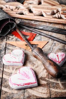 Symbolic wooden hearts cut by hand and carpenter tools