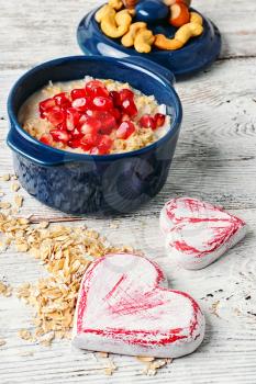 Blue pot of porridge decorated with pomegranate seeds