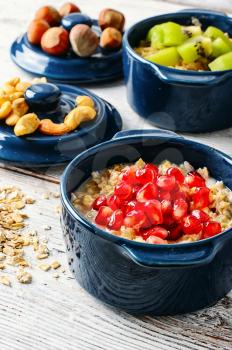 Blue pot of porridge decorated with pomegranate seeds