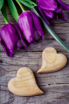 Three tulips and two symbolic hearts of wood