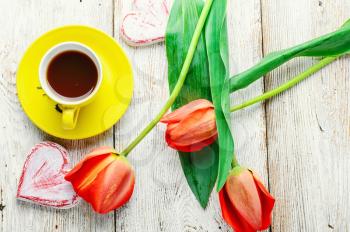 Lovely tulips,cup of tea and symbolic heart.Top view