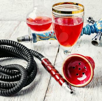 Details smoking Arab hookah and a glass of young wine pink
