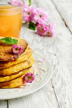pumpkin pancakes with light dishes and glass of juice