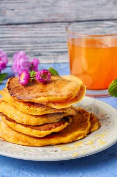  fritter pancakes with light dishes and glass of juice