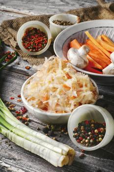 sauerkraut with spices and carrots in a wooden tub