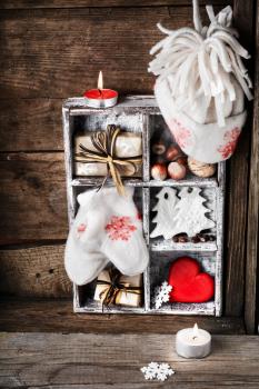 symbolic Christmas decoration with box mittens with Christmas tree and gifts