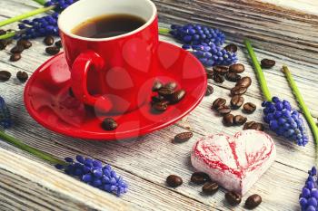 Red cup with coffee,flowers hyacinth and symbolic heart