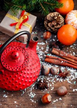 Stylish iron kettle,tangerines,and spices in Christmas still life