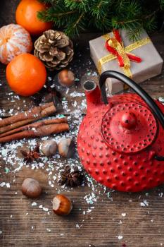Stylish iron kettle,tangerines,and spices in Christmas still life