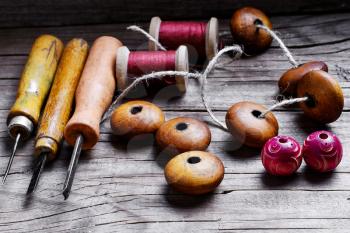 Vintage set awl,wooden beads jewelry laid out on wood