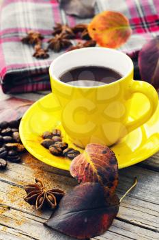 Cup of coffee,fallen autumn leaves and coffee beans