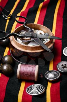 Scissors ,iron, stylish old-fashioned buttons and thread