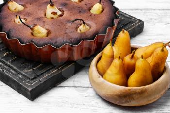 Baked sweet cake with whole pears in baking dish