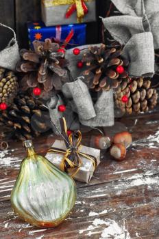 Christmas toy on the background of the Christmas wreath with pine cones