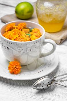 Cup of medicinal tea from the flowers of marigold