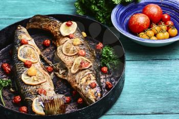 Whole baked fish in tomatoes,lemon and spices