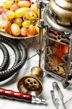 Arabic candle holder and hookah with ripe grapes
