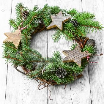 Noel wreath of fir branches decorated with Christmas star toys